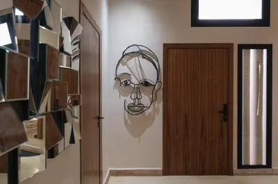 a drawing of a face on a wall next to a door at Riad Beldi Chic Golf Al Maaden in Marrakech