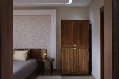a bedroom with a bed and a wooden cabinet at Riad Beldi Chic Golf Al Maaden in Marrakech