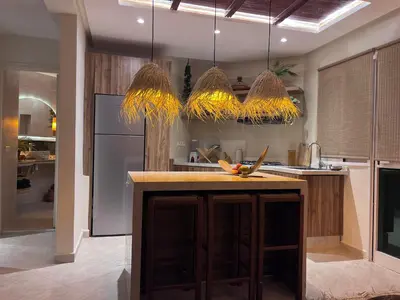 a kitchen with a island in the middle of it at Appartement Luxueux à Guéliz in Marrakech