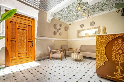 a room with a door and a couch and a table at Riad Ryme-Newly renovated-Exclusive-Free breakfast in Marrakech
