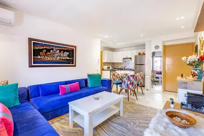 a living room with a blue couch and a table at AkHouse PB15 Fully Equipped - Guéliz TOP Center in Marrakech