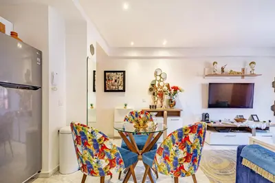 a kitchen and dining room with a table and chairs at AkHouse PB15 Fully Equipped - Guéliz TOP Center in Marrakech
