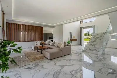 a living room with a couch and a table at Villa Arbia - Piscine - 5BDR - Fitness - Ping-Pong in Sraghna