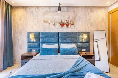 a bedroom with a blue bed and a mirror at Luxury CINÉMA-BEDROOM AK38 FullHD Guéliz-TopCenter in Marrakech