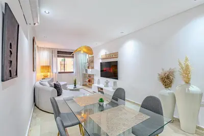 a living room with a glass table and a couch at Modern Apartment Gueliz City Center in Marrakech