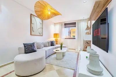 a living room with a couch and a tv at Modern Apartment Gueliz City Center in Marrakech