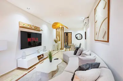 a living room with a couch and a tv at Modern Apartment Gueliz City Center in Marrakech