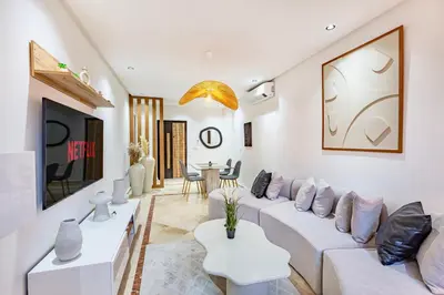 a living room with a white couch and a table at Modern Apartment Gueliz City Center in Marrakech