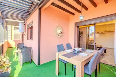 a dining room with a wooden table and chairs at Stylish Apartment with Terrace Central Marrakech in Marrakech