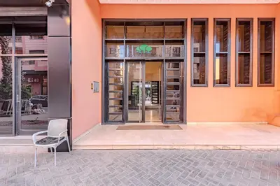 a building with a chair in front of it at Stylish Apartment with Terrace Central Marrakech in Marrakech