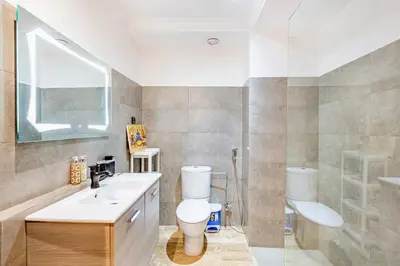 a bathroom with a toilet and a sink and a shower at Stylish Apartment with Terrace Central Marrakech in Marrakech