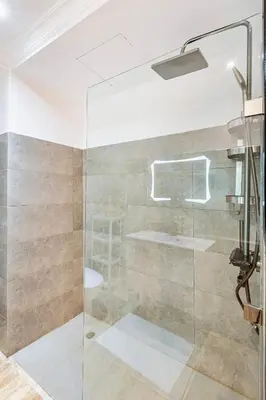 a shower with a glass door in a bathroom at Stylish Apartment with Terrace Central Marrakech in Marrakech