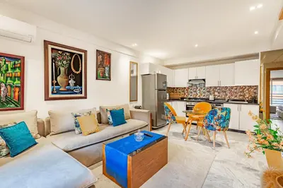 a living room with a couch and a kitchen at PB16 Flat Fully Equipped Guéliz TOP Center in Marrakech