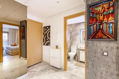 a bathroom with a toilet and a painting on the wall at PB16 Flat Fully Equipped Guéliz TOP Center in Marrakech