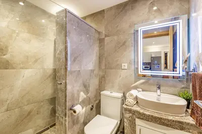 a bathroom with a toilet and a sink and a mirror at PB16 Flat Fully Equipped Guéliz TOP Center in Marrakech