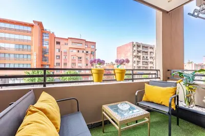 a balcony with furniture and a view of a city at Luxury CINÉMA-BEDROOM AK04 Guéliz-TopCenter in Marrakech