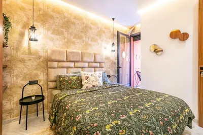 a bedroom with a large bed and a wall at HS14 Luxury 2Chambres Gueliz TopCenter in Marrakech