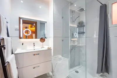 a white bathroom with a shower and a sink at Cinéma Pool Unique Experience Mkesh Top10 in Marrakech