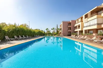 a swimming pool with lounge chairs and a hotel at Cinéma Pool Unique Experience Mkesh Top10 in Marrakech