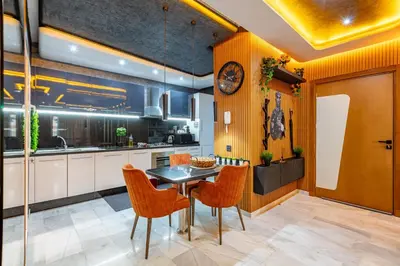 a kitchen with a table and orange chairs at Cinéma Pool Unique Experience Mkesh Top10 in Marrakech