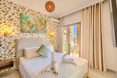 a bedroom with a white bed with a window and a bed sidx sidx at GUELIZ city center Perfect location with nice view in Marrakech