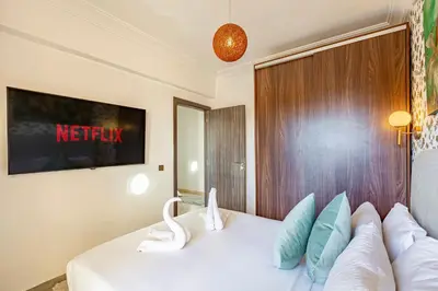 a bedroom with a white bed with pillows at GUELIZ city center Perfect location with nice view in Marrakech