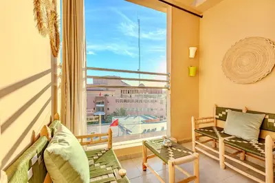 a room with two benches and a large window at GUELIZ city center Perfect location with nice view in Marrakech