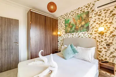 a bedroom with two white swans sitting on a bed at GUELIZ city center Perfect location with nice view in Marrakech