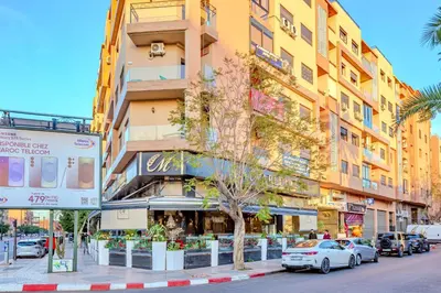 a street with cars parked in front of a building at GUELIZ city center Perfect location with nice view in Marrakech