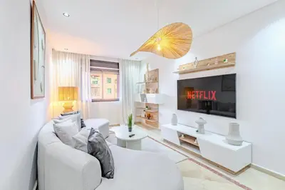 a living room with a couch and a tv at Manahil Modern Apartment Gueliz City Center in Marrakech