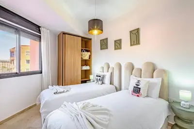 a bedroom with two beds and a window at Manahil Modern Apartment Gueliz City Center in Marrakech