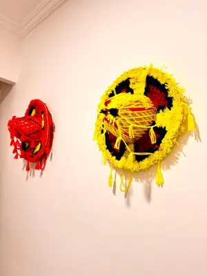 two pieces of art on a white wall at Lalla Mama medina house in Marrakech