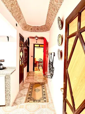 a hallway with a door and a tile floor at Lalla Mama medina house in Marrakech