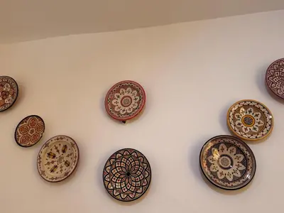 a group of decorative plates on a wall at Lalla Mama medina house in Marrakech