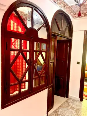 an entrance to a room with a door and windows at Lalla Mama medina house in Marrakech