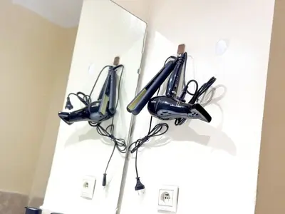 a room with three cell phones hanging on a wall at Majorelle Apartment - Terrace Stunning Garden View in Marrakech