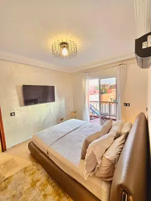 a large bed in a bedroom with a large window at Joli et chic Appartement à Marrakech - balcon privé et confort in Oulad Akkou