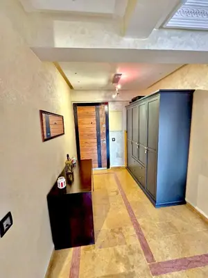 a room with a hallway with a desk and cabinets at Joli et chic Appartement à Marrakech - balcon privé et confort in Oulad Akkou