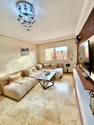 a large living room with a couch and a table at Joli et chic Appartement à Marrakech - balcon privé et confort in Oulad Akkou
