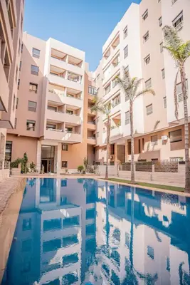 a swimming pool in front of some apartment buildings at Résidence Ménara Garden Proche Gare & Jardins Ménara in Marrakech
