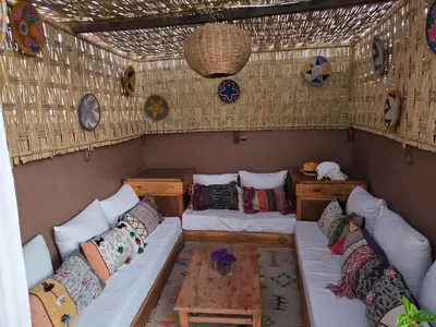 a room with a couch and pillows in a house at Authentic Riad & Jacuzzi in Marrakech