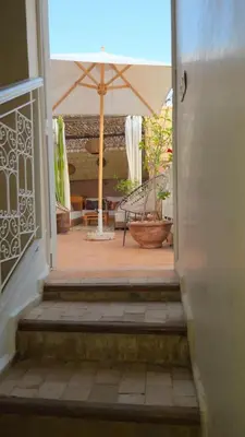 an open door to a patio with an umbrella at Authentic Riad & Jacuzzi in Marrakech