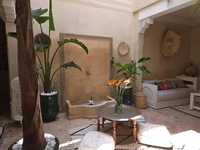 a living room with a couch and a table with plants at Authentic Riad & Jacuzzi in Marrakech