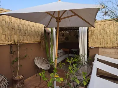 an umbrella sitting on top of a patio at Authentic Riad & Jacuzzi in Marrakech