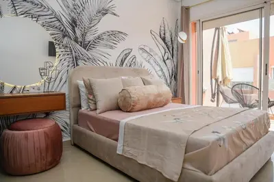 a bedroom with a bed and a plant wall at Cozy One-Bedroom Apart Wi-Fi, Netflix, and Balcony in Marrakech
