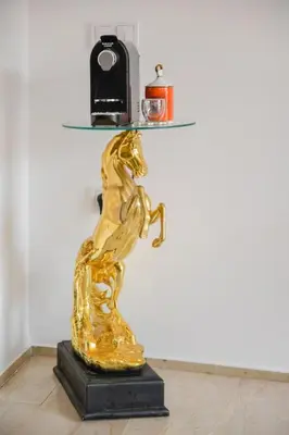 a gold statue of a horse on a black base at Cozy One-Bedroom Apart Wi-Fi, Netflix, and Balcony in Marrakech