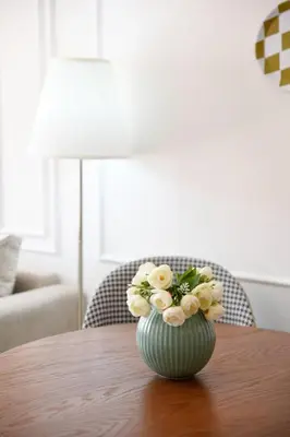 a vase filled with flowers sitting on a table at Cozy One-Bedroom Apart Wi-Fi, Netflix, and Balcony in Marrakech