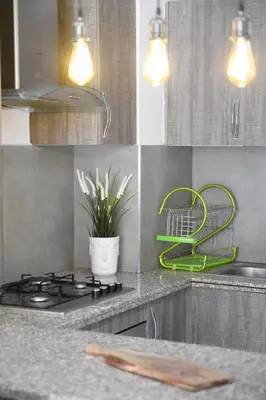 a kitchen with a stove and a green strainer at Cozy One-Bedroom Apart Wi-Fi, Netflix, and Balcony in Marrakech