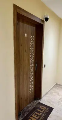 a wooden door in a room with a rug at Moderne appartement centre Marrakech in Marrakech