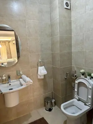 a bathroom with a toilet and a sink and a mirror at Moderne appartement centre Marrakech in Marrakech